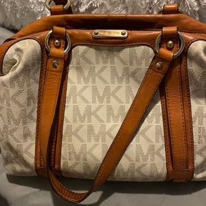 Authentic Michael Kors hand bag. No rips no tears, minor wear.